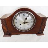 An oak cased mantel clock with  silvered dial and chrome bezel, with key and pendulum Est £10 - £15