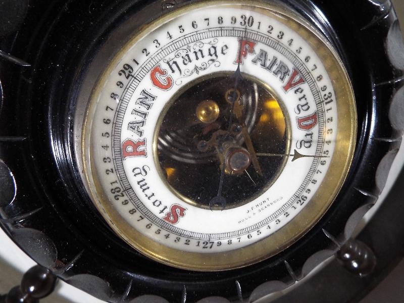 A wall mounted aneroid barometer in the form of a ships wheel, white enamel dial with open centre - Image 2 of 3