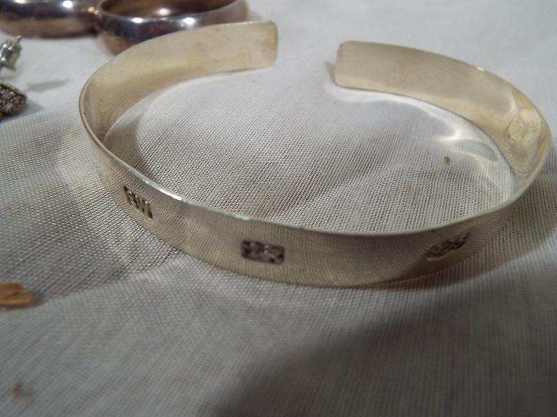 A collection of silver jewellery to include a hallmarked torque bracelet, earrings, necklace and - Image 2 of 2