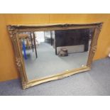 A gilt framed bevel edged wall mirror, 74cm x 105cm