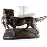 A large bronze sculpture depicting a gundog carrying a pheasant mounted on an Italian marble base,