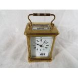 A French brass and glass panel carriage clock , Roman numerals on a white dial, with lever