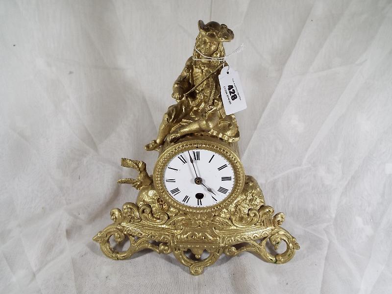 A spelter timepiece, Roman numerals on white dial, with pendulum - Est £20 - £40