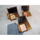 Three good quality vintage musical powder compacts, Swiss made by Agme, with briefcase shape and