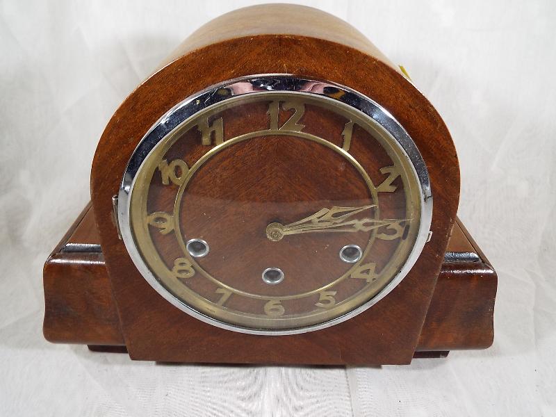 An Art Deco style mantel clock, oak case with applied skeletonised chapter ring and chrome bezel,