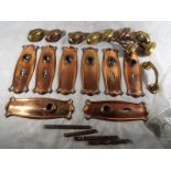 Reclamation - A quantity of early 20th century copper and brass door fittings, comprising knobs,