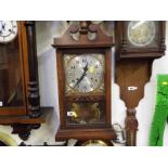 A wall mounted 31 day striking clock by Jupiter, with key and pendulum Est £10 - £15