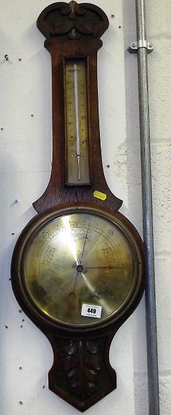 A wall mounted Arts and Craft style aneroid barometer, engraved brass dial and thermometer scale