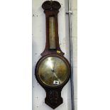 A wall mounted Arts and Craft style aneroid barometer, engraved brass dial and thermometer scale