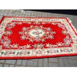 A red large wool rug 265cm x 152cm