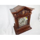 A bracket style mantel clock, the hour and half past gong strike movement by Jughans, the carved