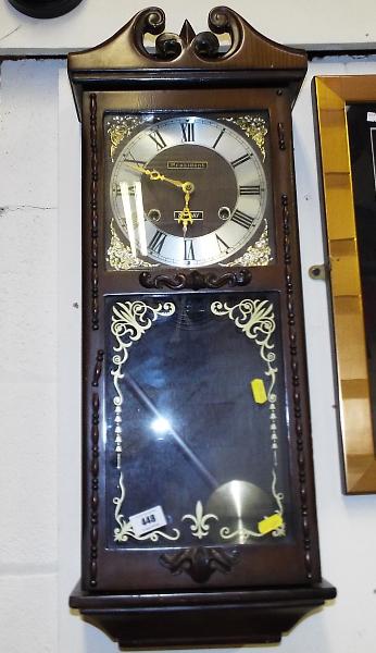 A 31 day wall clock by President opening glazed door showing pendulum, with key Est £10 - £20