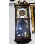 A 31 day wall clock by President opening glazed door showing pendulum, with key Est £10 - £20