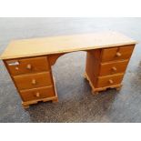 A pine dressing table, the knee hole flanked by two columns of three drawers, 78 cm x 144 cm x 44