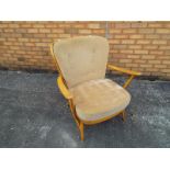 An Ercol light-wood arm chair with loose upholstery