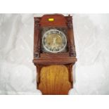 A wall clock with square brass dial and turned decoration to the wooden case Est £10 - £15