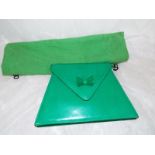 A lady's genuine Charles Jordan bright green envelope handbag with strap displaying logo's and zip