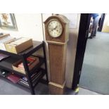 An oak cased grandaughter clock, Smiths hour and half past gong striking movement behind silvered