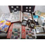 Philately -  three albums of UK and World postage stamps, two Stanley Gibbons stamp catalogues and