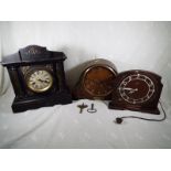 A group of three clocks to include an ebonised, German mantel clock, an electric ddark oak clock