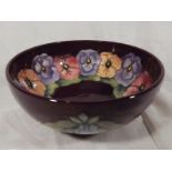 A Moorcroft large pedestal bowl decorated with pansy's on a magenta ground 9cm (h) x 20.5cm (dia) -