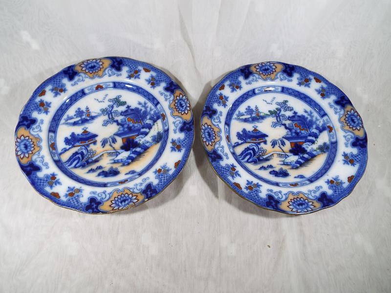 A pair of Chinese plates decorated with an Oriental scene, 6 point character mark to the base and