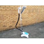 A Tobi model # EC-1633, the world's first upright and portable wrinkle removal machine, with manual