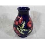 A Moorcroft Pottery vase decorated with anemones on a cobalt blue ground, 13.5cm (h)