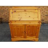 A good modern pine writing bureau with slope front opening to reveal a fitted pigeon-hole interior,