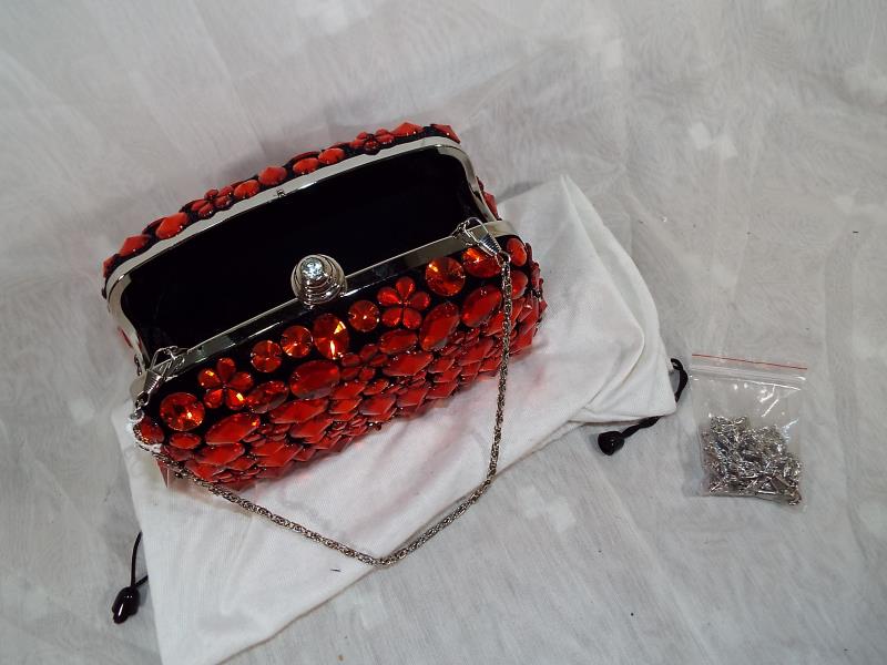 A lady's Butler & Wilson hard cased evening bag with gem stone decoration in red, spare strap and - Image 3 of 3