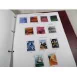 A Stanley Gibbons country stamp album containing a collection of predominately UK mint stamps with