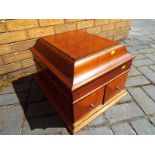 An empty gramophone cabinet, the hinged lid marked Academy