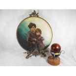 An oil painting on a large wooden plaque depicting a boy and girl in vintage costume, 40cm (diam)