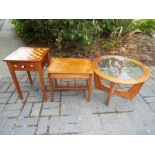 A mid century oak round topped coffee table with glass top and two other occasional tables