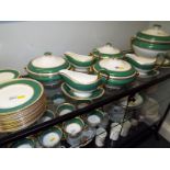 A 78 piece Wedgwood dinner service decorated in marbled green on an ivorine ground with gilded