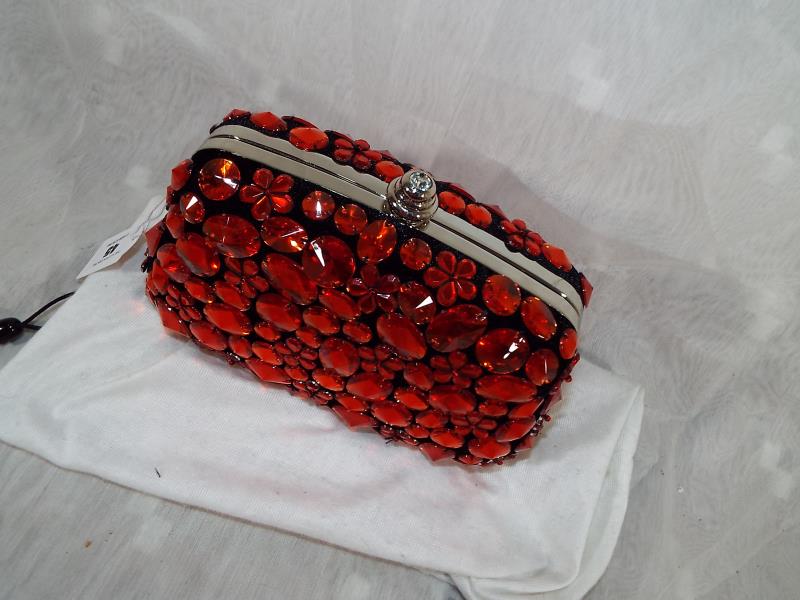 A lady's Butler & Wilson hard cased evening bag with gem stone decoration in red, spare strap and - Image 2 of 3