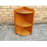 An Ercol wall mounted corner shelf unit, 69 cm x 31 cm x 31 cm