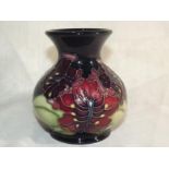 A Moorcroft Pottery modern bulbous vase decorated with fruits on a cobalt blue ground, 9.5cm (h) -