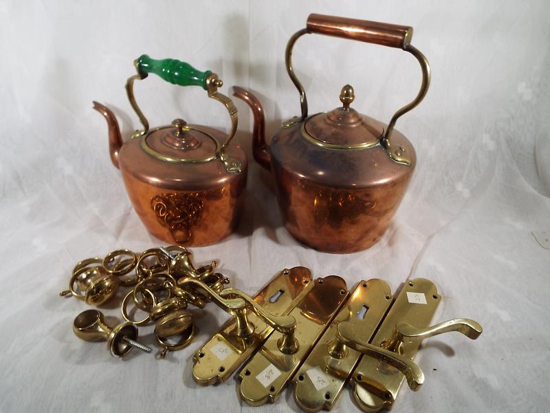Two copper kettles and a small quantity of brass door furniture
