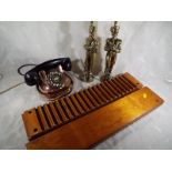 An early 20th century copper and brass telephone, a DRGM cigar press and a pair of brass fireside