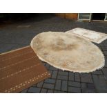 Two pure wool rugs and one other, one pure wool rug with floral design on a biscuit coloured ground