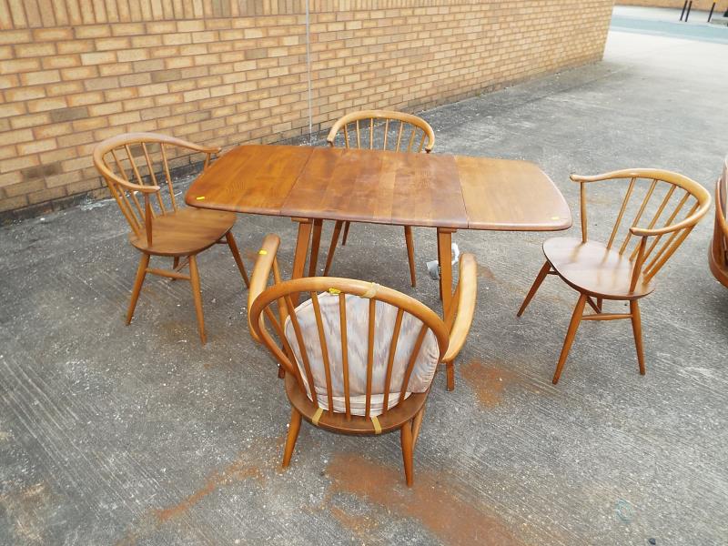 An Ercol light elm drop-leaf dining table, elm top, beech body and four Ercol dining chairs - Est