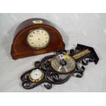 A A polished and inlaid wood cased wind-up mantel clock together with a decorative wall-mounted