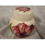 A Moorcroft Pottery lidded ginger jar decorated with pink magnolia on an ivorine ground, 11.5 (h) -