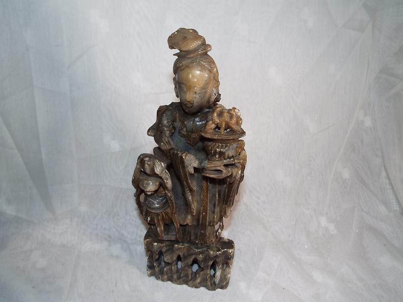 A hard stone carved oriental figure depicting a lady and child 30cm (h)