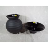 A Wedgwood ribbed vase, 21cm (h) and bowl, 10cm (h), both by Nick Munro, black basalt finish (2)