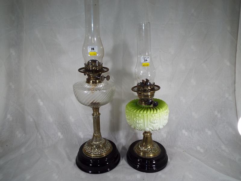 Two early 20th century brass oil lamps, one with green vaseline glass reservoir, marked ALC, 56cm