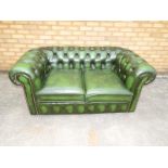 A green leather Chesterfield two seater sofa 70cm x 150cm x 85cm