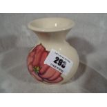 Moorcroft Pottery - A vase decorated with pink magnolia on an ivorine ground, 9cm (h) - Est £40 -