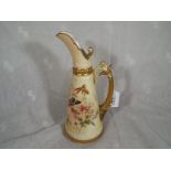 A late 19th century Royal Worcester ewer with gilt floral decoration depicting a butterfly on a